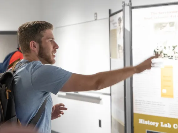 Undergraduates looking at history display