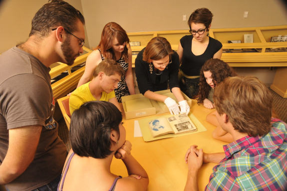 Students and instructor examining an artifact